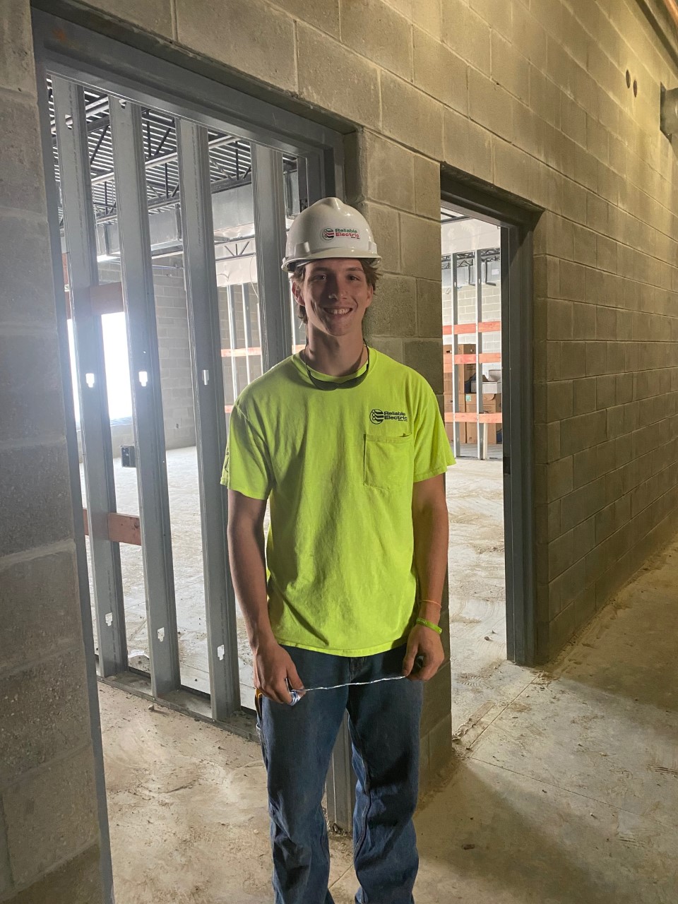 young man with hard hat and safety tshirt